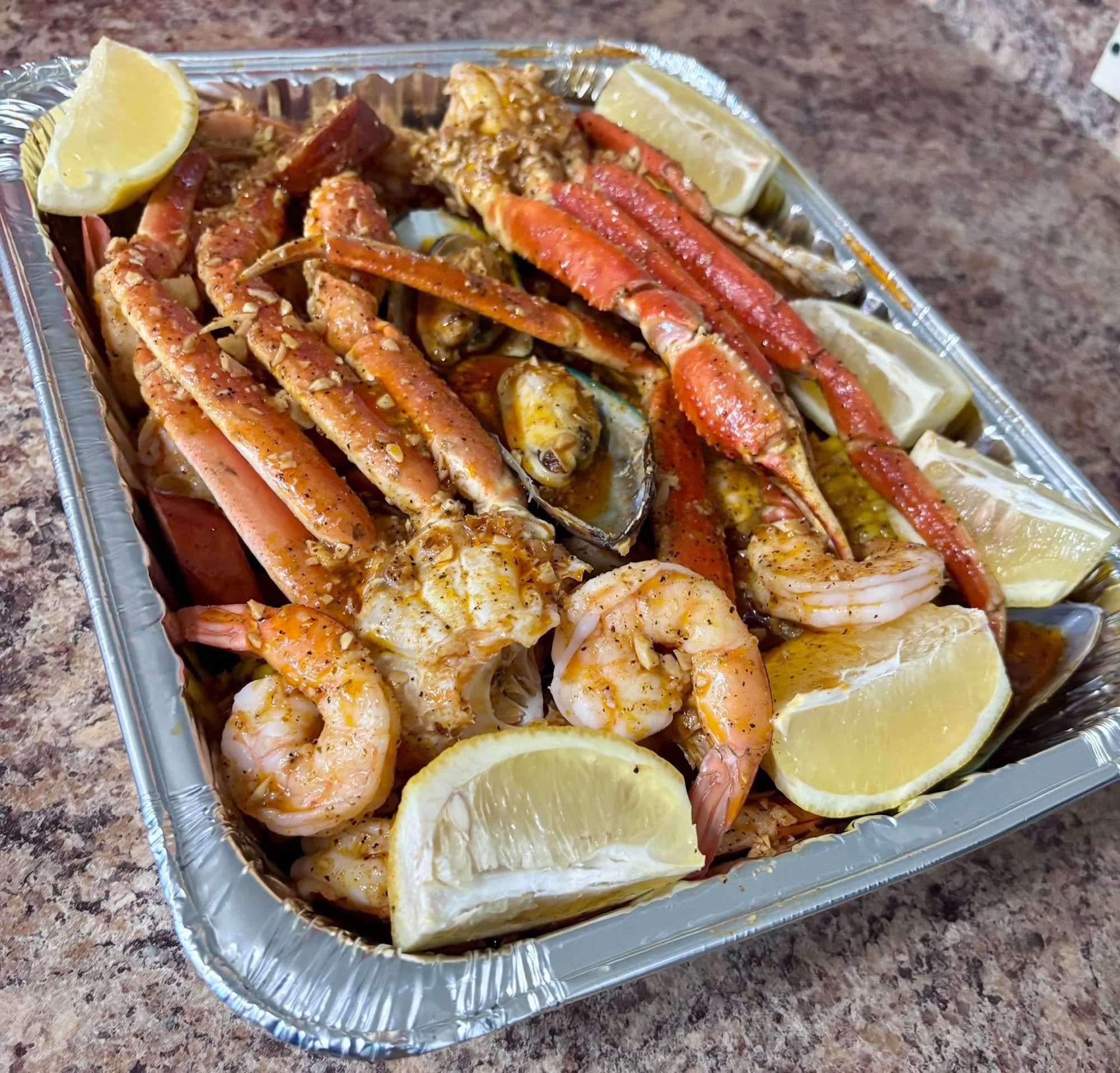 Boil Society Co. seafood boil with crab legs, shrimp, and mussels